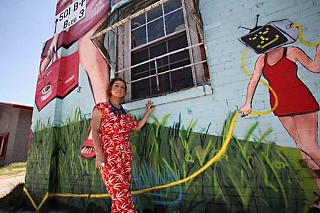 Scarlett Vivienne stands outside 501 Pedernales, which until recently housed her hair salon, as well as artists' studios, a theatre company, and a recording operation.