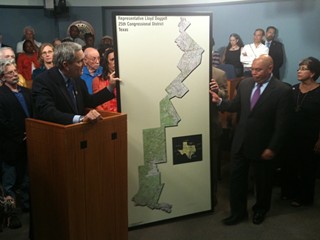 Congressman Lloyd Doggett (left) in a press conference on redistricting earlier this year, showing a map of the 2003 gerrymander