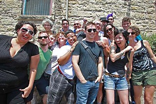 QueerBomb Collective & Friends: (l-r, front row) Risa Puleo, Matt Korn, Silky Shoemaker, d.king, Tamicka Phillips, Brett Hornsby, Paul Soileau, Melissa Smith, Beth Schindler, Raven Hinojosa; (l-r, back row) Joanna Labow, Kate Messer, Joe Sanchez, Bobby Johns (derby hat), Sym Prole, and Albert Dixon