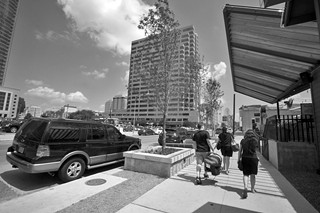 Sidewalks and newly planted trees add life to  this once-drab street.