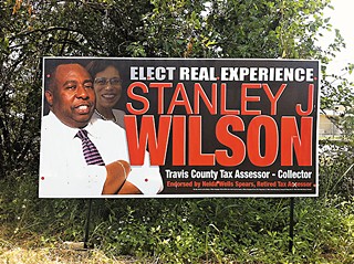 A campaign sign for candidate Stanley J. Wilson includes a photo of his former boss, Nelda Wells Spears.