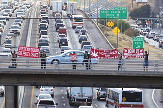 Members of the Texas Hemp Campaign proudly displayed their support on Nov. 30 for the legalization of marijuana. For the past three years, the campaign has dropped its banners from the 11th Street bridge on the last Friday of every month.