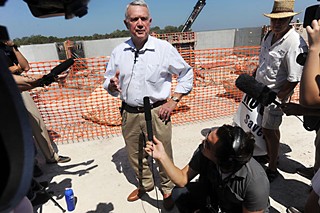 Mayor Lee Leffingwell, speaking at the WTP4 site in 2011, defended the project's $15 million overrun.