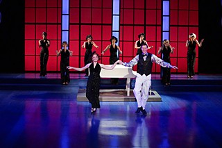 Santa brought somebody tap shoes: Elizabeth Koepp, Matt Gibson, and chorus in <i>White Christmas</i>.