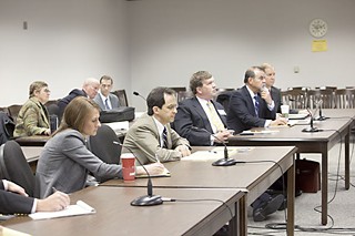 Lawyers on all sides gather March 1 at the Public Utility Commission, including (front row, l-r) Melissa Long and Thomas L. Brocato, co-counsel and lead attorney, respectively, for Austin Energy; Roger Borgelt, representing HURF; Alfred Herrera, for intervenor FAIR; and James Rourke of the Public Utility Counsel.