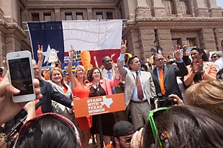 Sens. Wendy Davis and Leticia Van de Putte, joined by Democratic legislators, receive a rousing welcome from the crowd at Monday's rally.