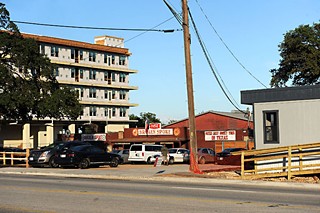 They paved paradise, put up a parking lot plus apartments, a sidewalk, and a fence around the old Spoke Oak. It's overkill, mutters James White.