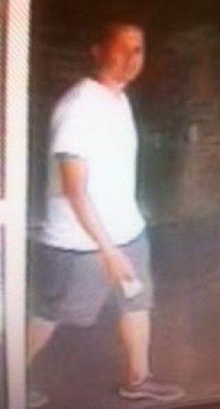 This surveillance photo was taken outside Benchmark Bank shortly before the fatal shooting; police believe this man may have witnessed the shooting.