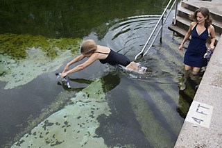Laura Morrison plunges into the chilly waters of Barton Springs while Kathie Tovo eases into the pool for a snorkeling tour as part of last week's Council Fixes the Pool Day to discuss the city's efforts to improve the pool and grounds.