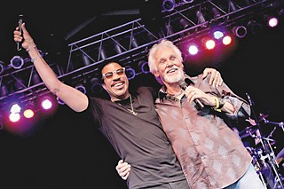 Lionel Richie (l) joins Kenny Rogers as a surprise guest during the 2012 Bonnaroo Music and Arts Festival.