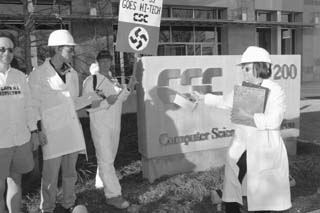 Anti-war activists carry out a weapons inspection at the Computer Sciences Corporation building downtown. The mock inspection was in protest of CSC's recent acquisition of DynCorp, a major military contractor. The inspection was carried out by members of the Military Documentation Project and the Anti-War Working Group.