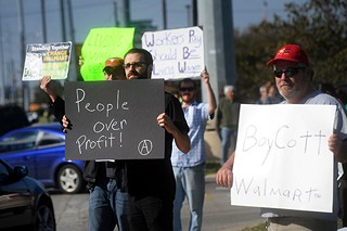 Austin activists joined a national protest effort on Black Friday to call attention to Wal-Mart's poverty wages for its workers, which forces the retail giant's low-income workers to rely on public assistance and charity to make ends meet.