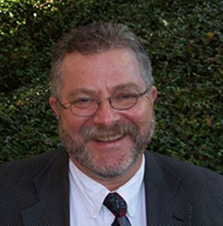 ACC Trustee Tim Mahoney says the board was kept out of the loop on the administration's decision to cut health coverage.