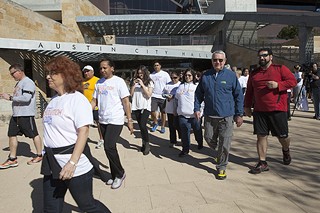 Resolving to beef up their workout routine in the new year, participants help Mayor Lee Leffingwell kick off Wednesday's 1.5-mile trek from City Hall to the trail around Lady Bird Lake.