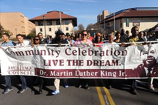 Former State Rep. Wilhelmina Delco (second from right) helps carry Austin Area Heritage Council's banner honoring the legacy of Martin Luther King Jr., on Monday. See <b><a href=http://austinchronicle.com/>austinchronicle.com</a> </b>for a photo gallery of MLK Day events.