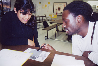Student Keila Castaneda and teacher Ken Loyd work after hours on a homework assignment at the KIPP Academy.