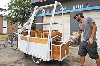 Christian Klein of Drophouse Design demonstrates one of the many moving parts of the food cart.