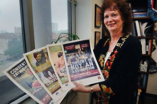 Jane Bost, associate director of Prevention and Outreach Services at UT's Counseling and Mental Health Center, displays posters designed to educate students about the necessity of consent in sexual relationships.