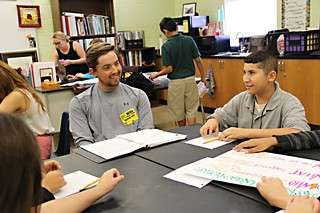 UT Law student and volunteer Danny Williams (l) works with students through the Youth Court at Webb Middle School.