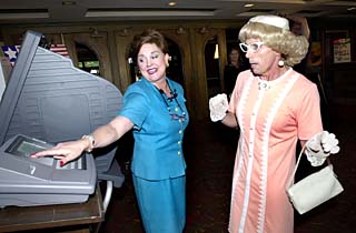 Travis County Clerk Dana DeBeauvoir and Vera Carp, a mayoral candidate from Tuna, Texas, demonstrate the county's new eSlate electronic voting system in front of the Paramount Theatre Wednesday morning. DeBeauvoir hopes that the new system will speed up the county's notoriously slow vote-counting process. Previous counts have often lasted well into the night, but DeBeauvoir expects to be done with the May 3 municipal elections before the 10pm television news. It is also expected to reduce vote-counting in Tuna's elections from 10 minutes to less than two.