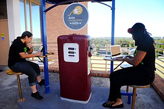 Erazo and Jackson use the SolarPump charging station installed outside the Dickey-Lawless Science Building