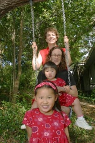 Suzanne Bryant (top) and her partner Sarah Goodfriend with children Ting Lan and Dawn