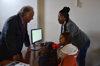 State Sen. Kirk Watson, D-Austin, visits with students of a new computer lab at an east side public housing development, part of HACA and Google Fiber's new digital inclusion plan.