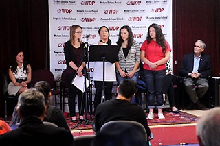 The Workers Defense Project's Cristina Tzintzun (l), immigrant families, and Congressman Lloyd Doggett (r), discuss the recent court injunction against immigration reform.