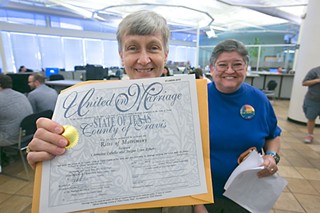 Jacque Lynne Roberts (l) and Carmelita Cabello receive a marriage license at
the Travis County Clerk's Office.
