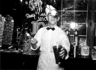 Soda jerker flipping ice cream into malted milk shakes, Corpus Christi, Texas, February 1939