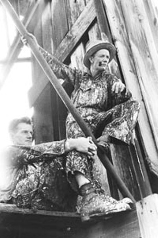 Roustabouts during a lull in painting of derrick. Seminole Oil Field, Okla., August 1939
