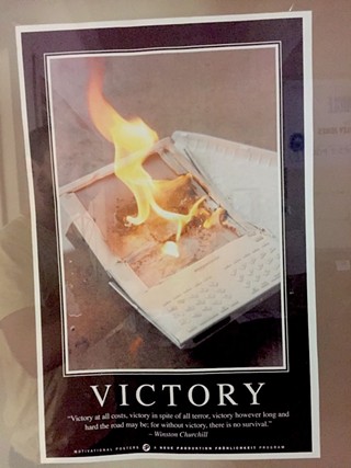 I don't have a bedside table, or any books to put on it, anyway, not since I made the switch to an iPad. What I do have is this motivational poster Creative Director Jason Stout made me after we set fire to my parents' first-generation Kindle for a cover shoot in 2012.