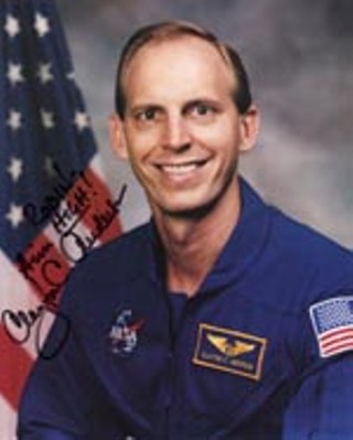 Teetotaling Nebraskanaut Clayton C. Anderson
autographs 8-by-10 glossies with Aim High!