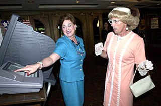 Travis Co. Clerk Dana DeBeauvoir has pushed hard to educate voters about the eSlate electronic voting system, including this 2002 photo-op with <i>Greater Tuna </i>actor Jaston Williams (in character as Vera Carp).
