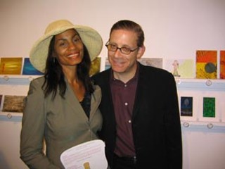 The <i>Stateman</i>'s Alberta Phillips and <i>Texas Monthly'</i>s Evan Smith standing before some of the hundreds of pieces of art at Arthouse's fabulous 5x7 show