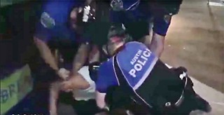 APD officers wrestle King's friend Matthew Wallace to the ground. The video that captured their arrest has since been taken offline.