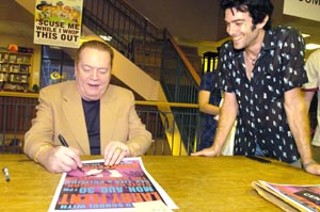 Larry Flynt signs posters for local poster artist Jason Austin, who made the poster for the BookPeople signing.