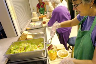 Volunteers preparing meals at Caritas