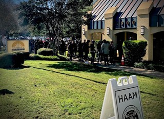 The long line outside HAAM's office at Foundation Communities on the opening day of enrollment