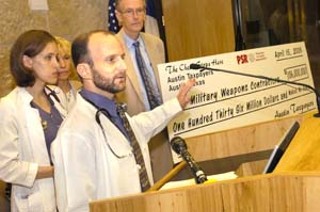 On Monday, Lisa Doggett and Greg Sheff (in lab coats) of the Austin chapter of Physicians for Social Responsibility presented to City Council Members Jackie Goodman and Daryl Slusher a symbolic check for $136 million, representing Austin's share of U.S. military spending.