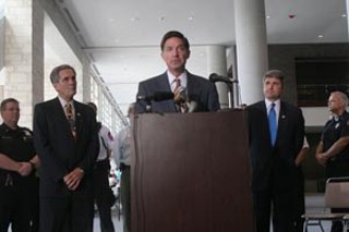Mayor Will Wynn, flanked by U.S. Reps. Lloyd Doggett and Michael McCaul, speaks about federal assurances of reimbursement for local expenditures from the Hurricane Katrina emergency.