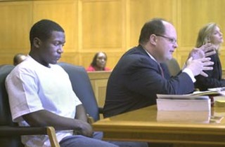 Marcus McTear (left) with his attorney in court last week; the teenage killer of Reagan classmate and ex-girlfriend Ortralla Mosley was transferred from juvenile prison to incarceration with the Texas Department of Criminal Justice.