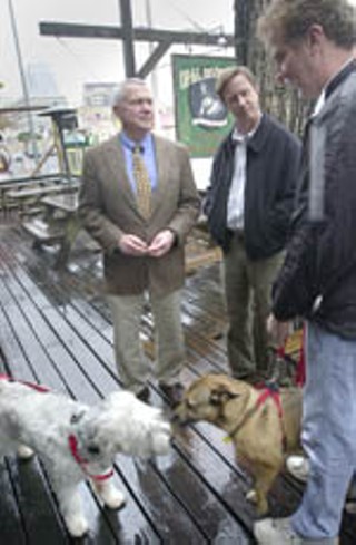 Council Member Lee Leffingwell chats with fellow dog-
lovers at Opal Divine's on a drizzly Friday, while their
four-legged friends sniff each other out – if only
politics were so straightfoward. Leffingwell, along with
Brewster McCracken, is a co-sponsor of Jennifer Kim's
resolution permitting dogs in outdoor dining areas of
restaurants, like the patio of pooch-friendly Divine's. The
item is scheduled for discussion and assured passage
today.