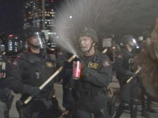 Austin Police Cmdr. James O'Leary shoots protesters with
pepper spray at a March 20, 2003, anti-war rally on the
Congress Avenue Bridge. Last week, a federal grand jury
deliberated for nine hours before deciding that O'Leary
did not use excessive force in firing the spray, even
though the crowd on the bridge was essentially
nonviolent. See Point Austin.