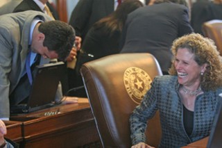 Laughing to keep from crying? Newly elected Democrat
Donna Howard of Austin shared a moment of humor with
sophomore Austin Dem Mark Strama on the opening day
of the Legislature's special session on property tax
reform and public education financing.