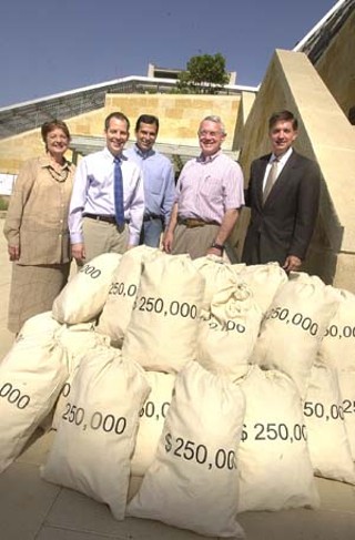 City Council Member Betty Dunkerley, Walter Moreau of Foundation Communities, Council Members Raul Alvarez and Lee Leffingwell, and Mayor Will Wynn (l-r) displayed bags of (fake) money on Tax Day this year, representing the approximately $13 million that the free Foundation Communities Tax Centers put back into Central Texas wallets by helping taxpayers claim their earned income tax credits and refunds. About 15% of the roughly 10,000 people served by the centers are undocumented immigrants.
