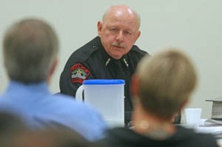 As former Austin Police Officer Julie Schroeder (foreground) listens, APD Chief Stan Knee testifies on his reasons for firing her after she shot 18-year-old Daniel Rocha.