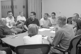 SRCC member Dawn Cizmar speaks to the Planning Commission subcommittee on codes and ordinances. Reacting to her comments are (l-r) city staff member Rolando Fernandez, neighborhood activist Jeff Jacks, translator Raul Ramirez, and AVATACO representatives Polo Cadena and Esmael Lozano.