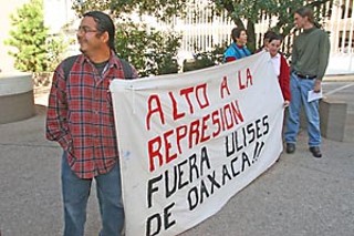 A small group of Austinites went to the Mexican 
Consulate Friday, Oct. 20, to show support for protesters 
in Mexico's southern city of Oaxaca, who are demanding 
the resignation of Gov. Ulises Ruiz. They say Ruiz's 2004 
election was fraudulent and that his government has 
consistently retaliated against dissenters. The banner 
Oaxacan organizer Omar Angel (l) and Marissa Villarreal 
Avila (r) are holding reads stop the repression and out 
with Oaxaca's Ulises.