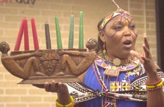 Elizabeth Kahura explains the significance of the seven candles as part of a Kwanzaa celebration at Carver Library on Dec. 27. The Kwanzaa holiday was founded in 1966 by Dr. Maulana Karenga, and according to organizers of the Carver celebration, it is neither political nor religious and despite some misconceptions, is not a substitute for Christmas. It is simply a time of reaffirming African-American people, their ancestors and culture.